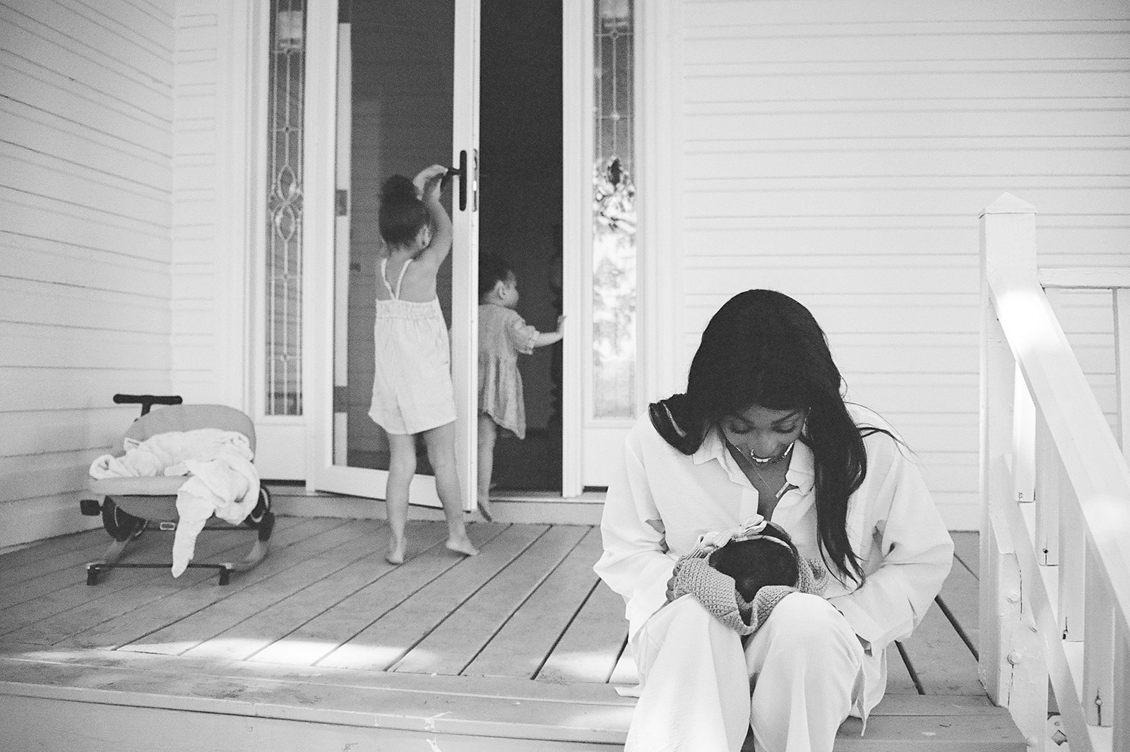 Black and white photos of toddlers playing on the porch