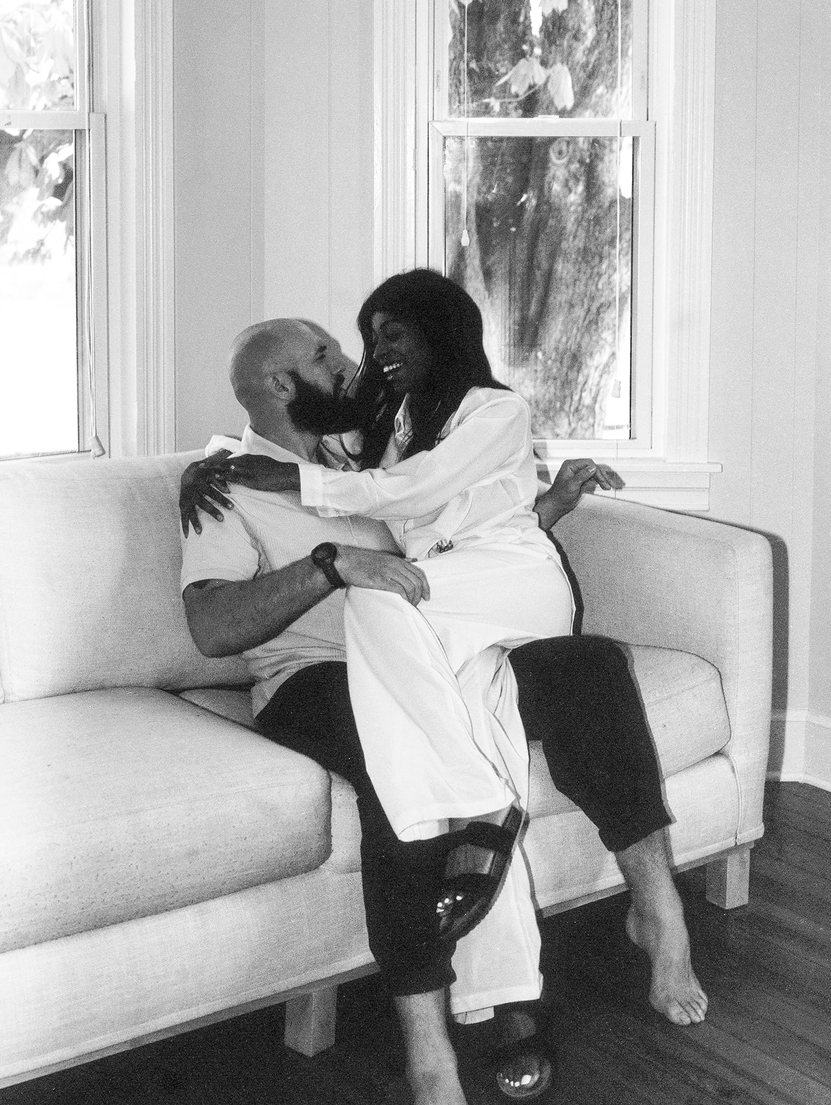 A husband and wife cuddle on the couch in their West Virginia home 