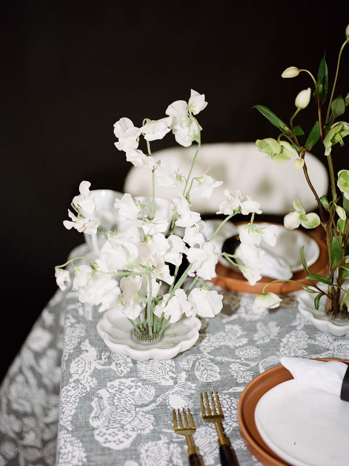 White florals on a patterned linen tablecloth