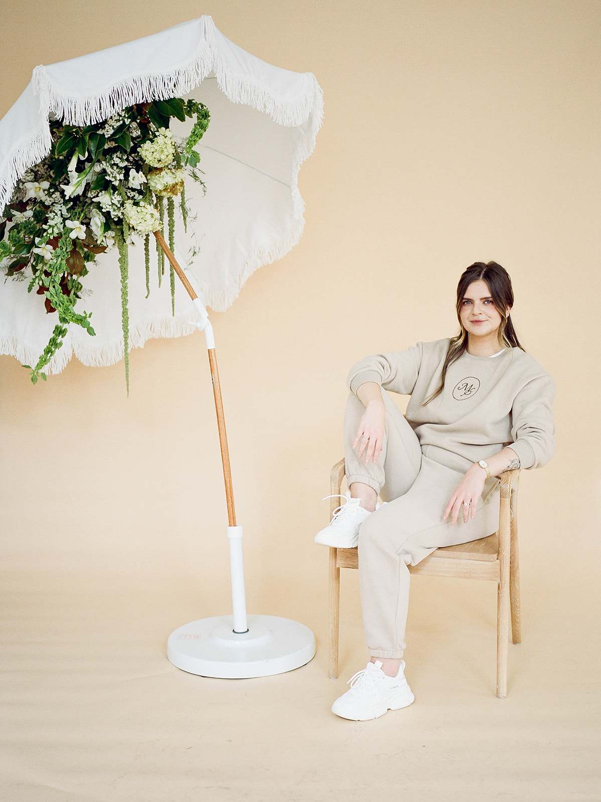 A wedding planner in a custom beige sweatsuit