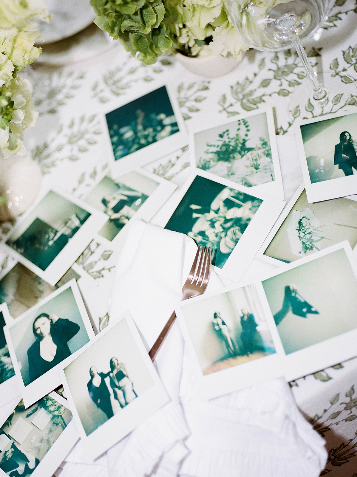 Polaroid brand photos spread across a table