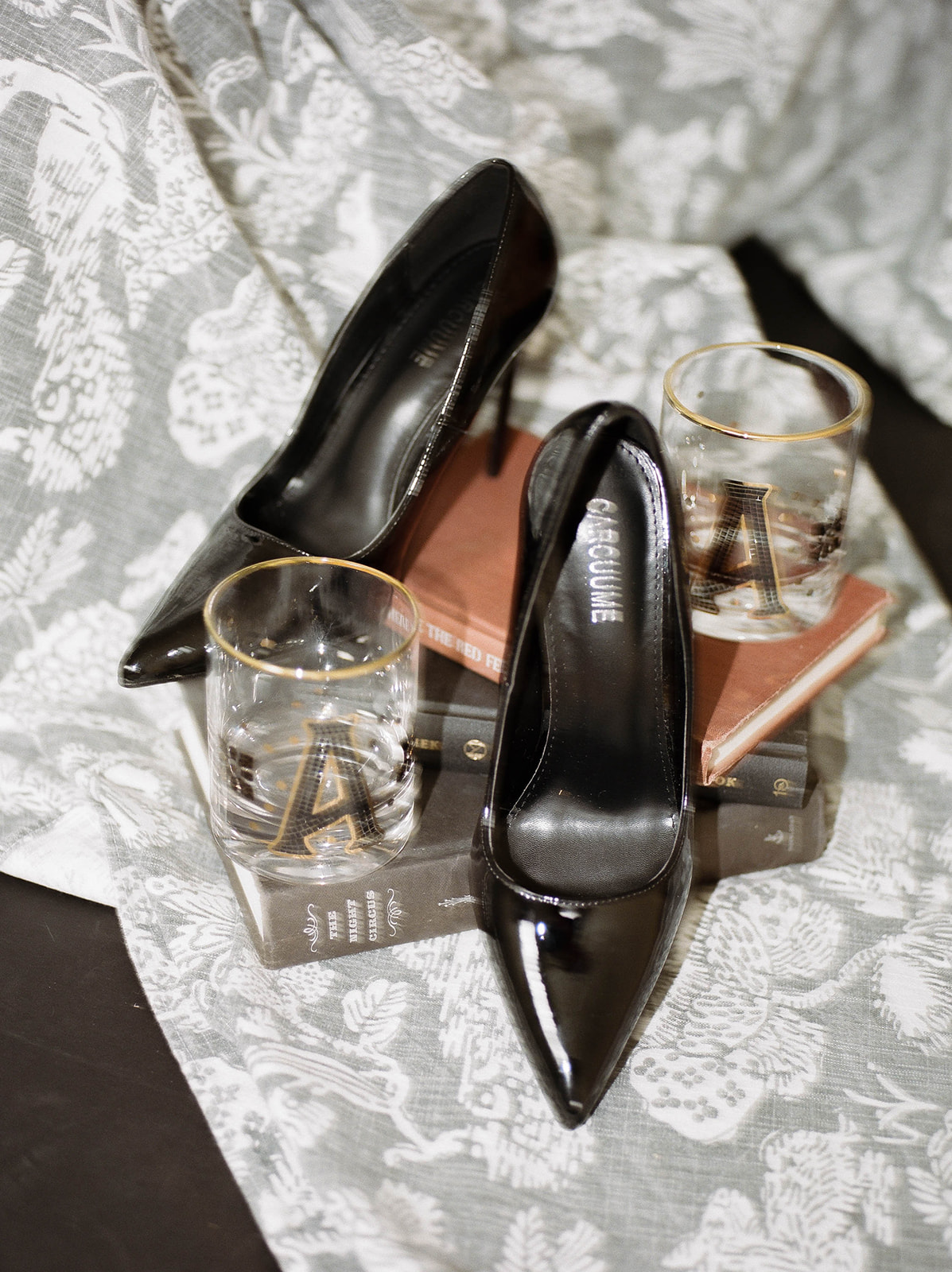 Patent leather shoes and a pile of books