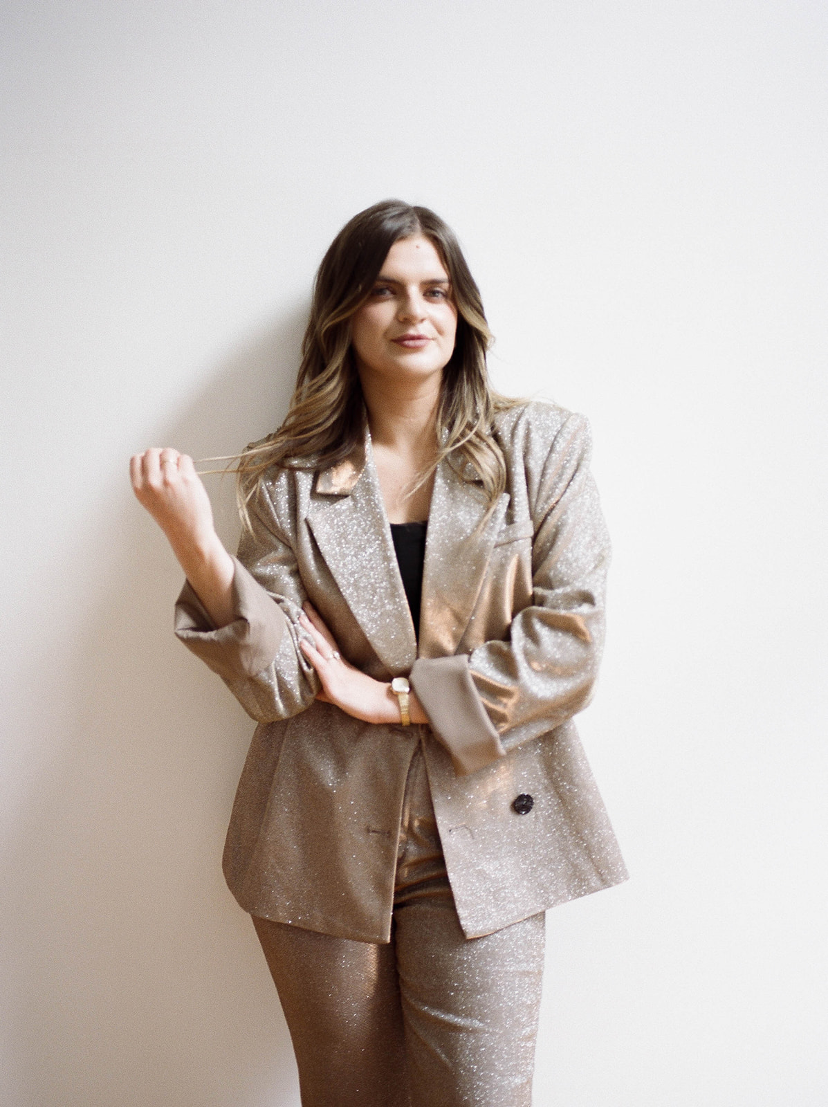 A brand photo of a wedding planner in a beige sparkly suit
