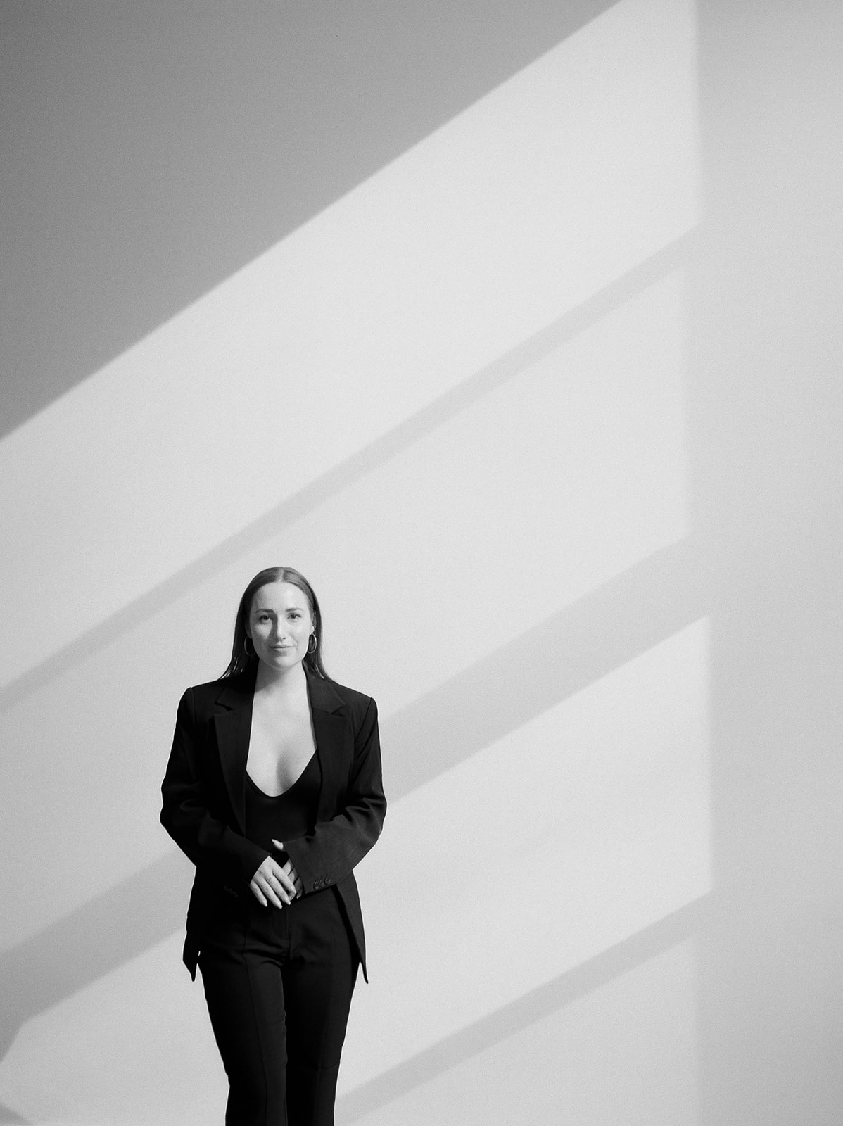 Brand photos in a baltimore studio for a wedding planner in a black suit
