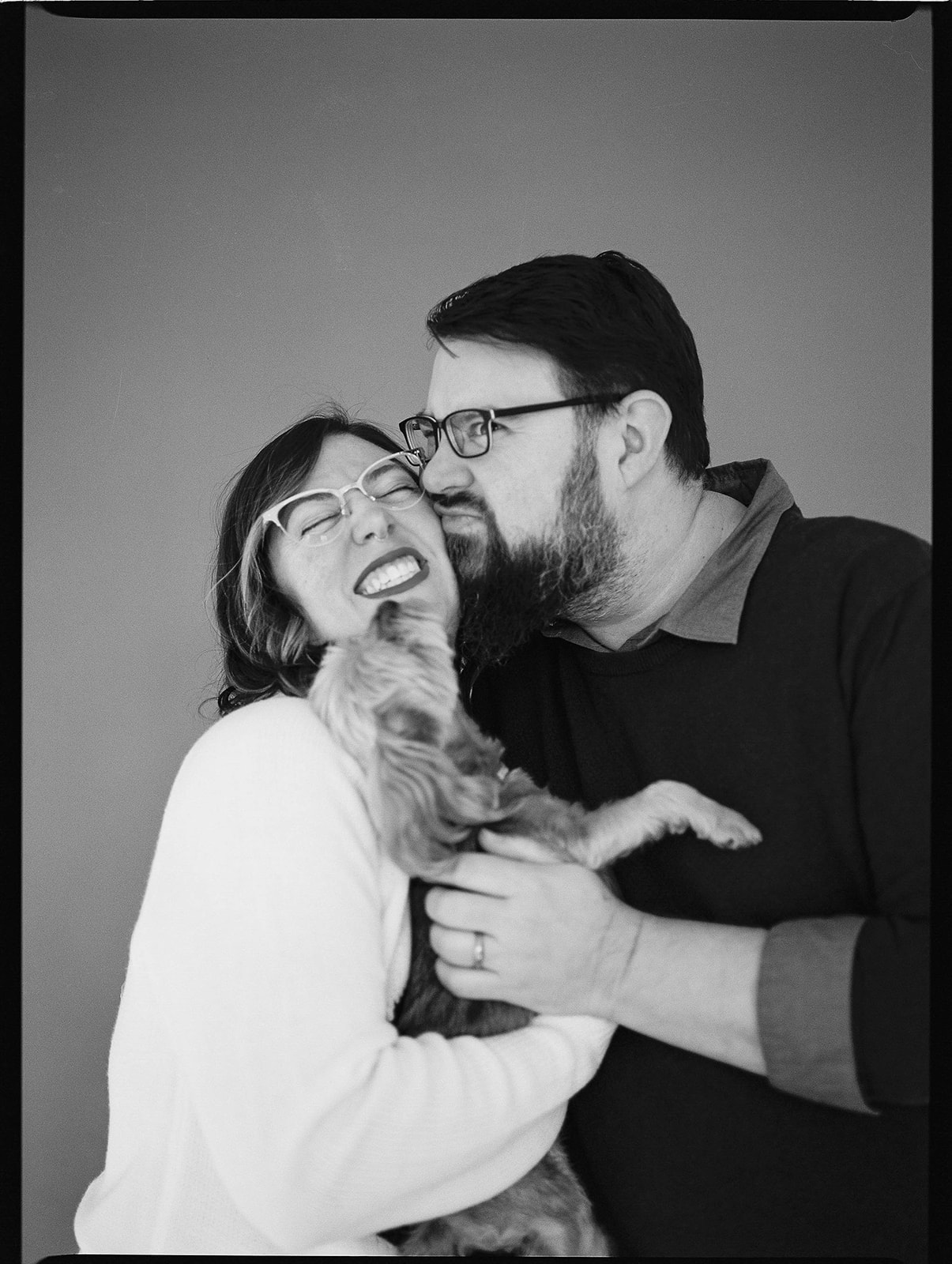 A man, woman, and dog during studio family photos in Baltimore