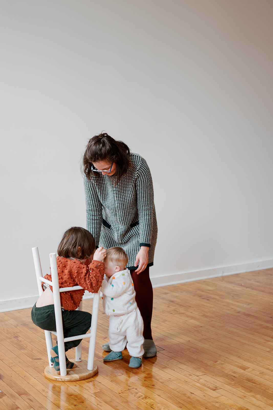 A mother and two sons playing during studio family photos in Baltimore