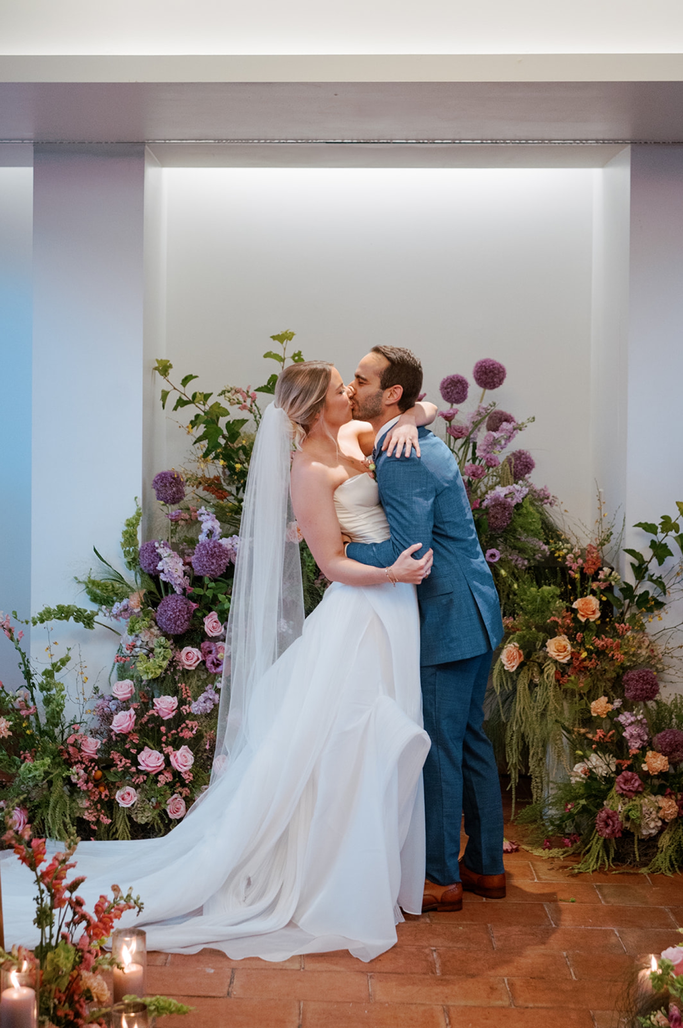 A bride and groom kiss after exchanging vows at their wedding ceremony at the Line Hotel in D.C.