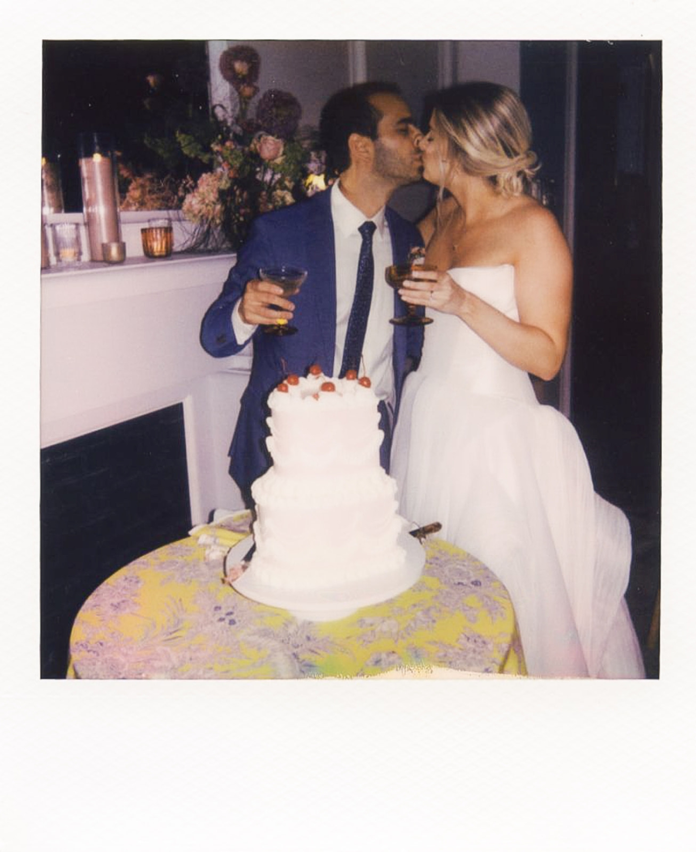 A Polaroid of a bride and groom cutting their wedding cake 