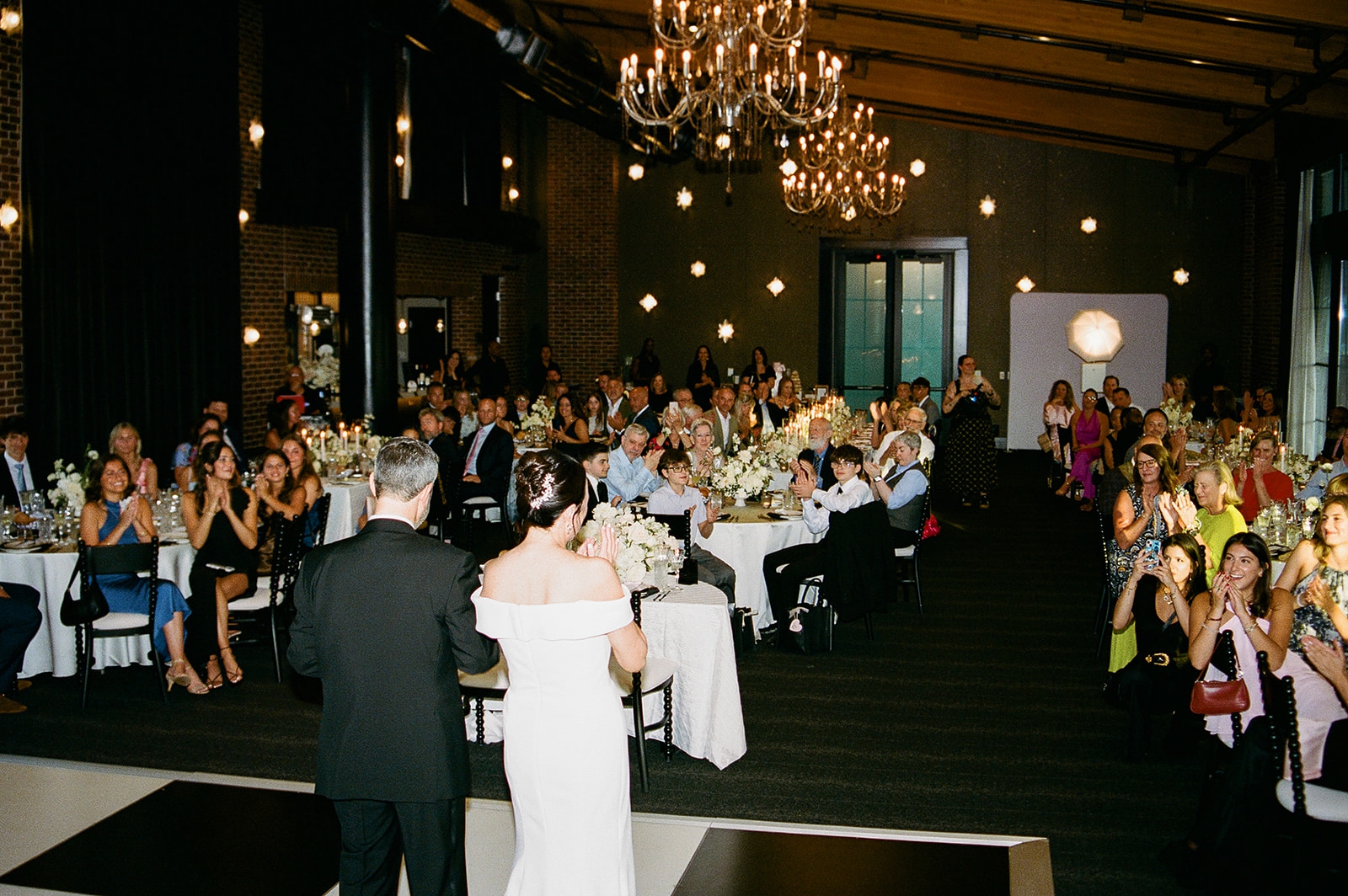 The large ballroom at the Archer Hotel Tysons full of guests during a wedding reception 