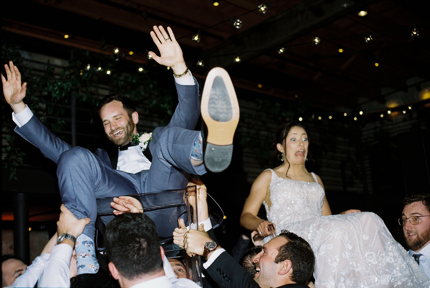 A bride and groom laughing during the Hora 