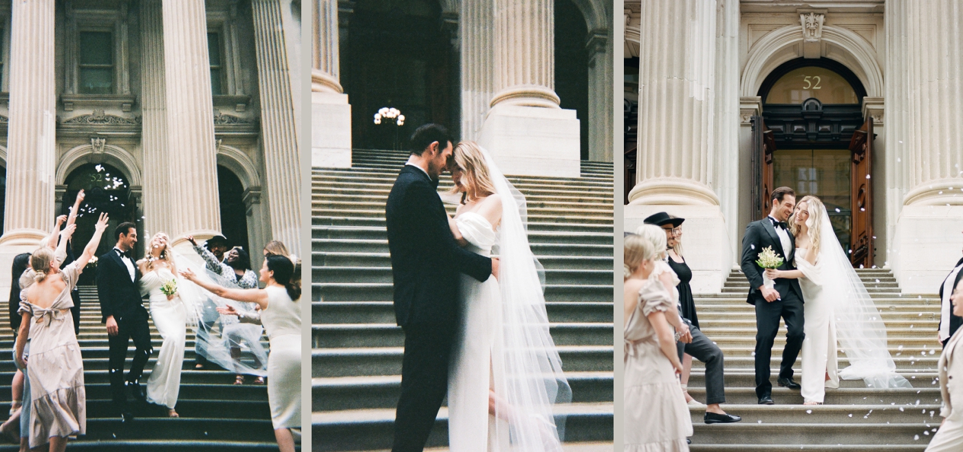 A bride and groom being showered by flower petals by their close friends and families