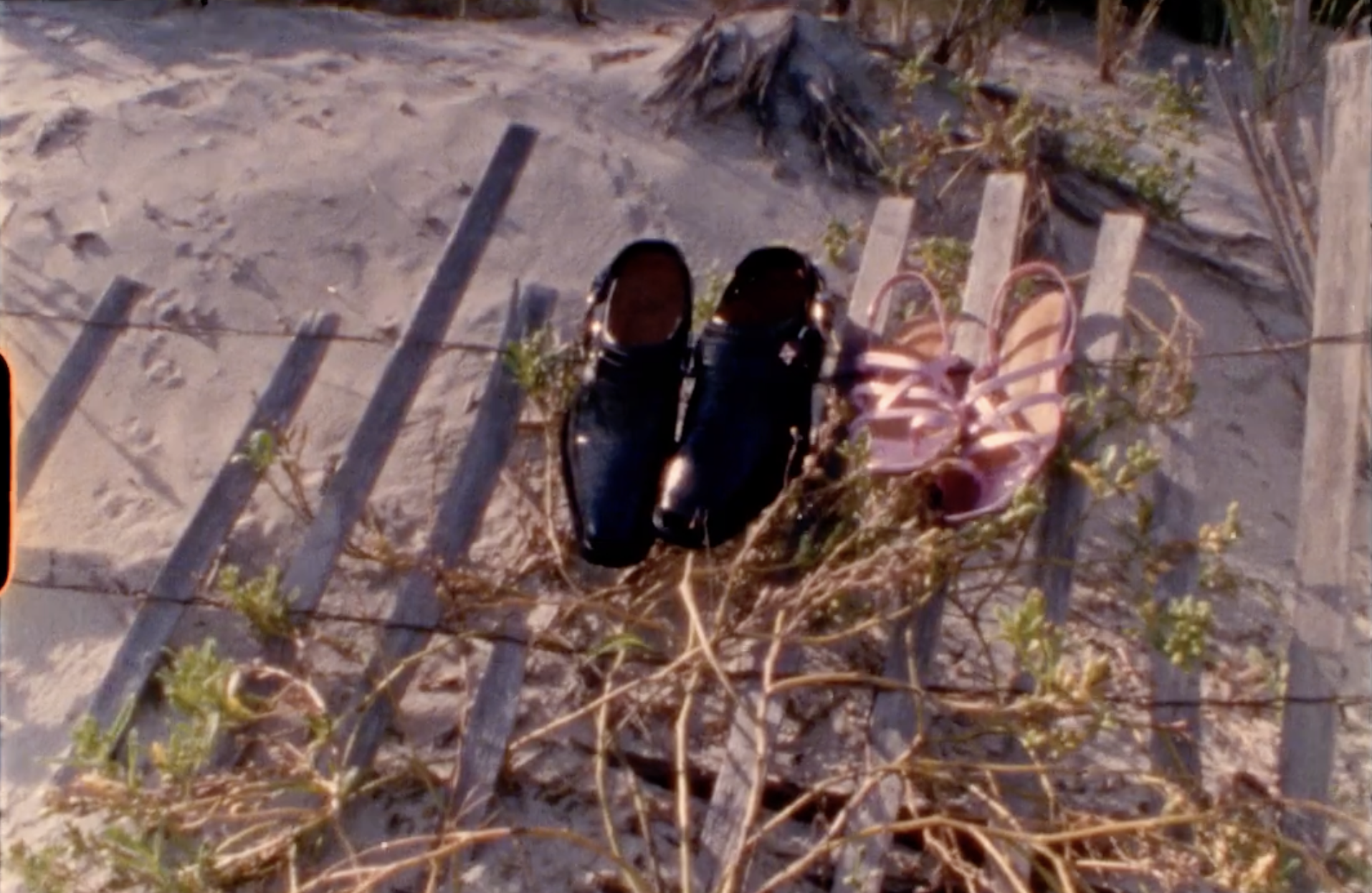A Super 8 screenshot of shoes on the beach 