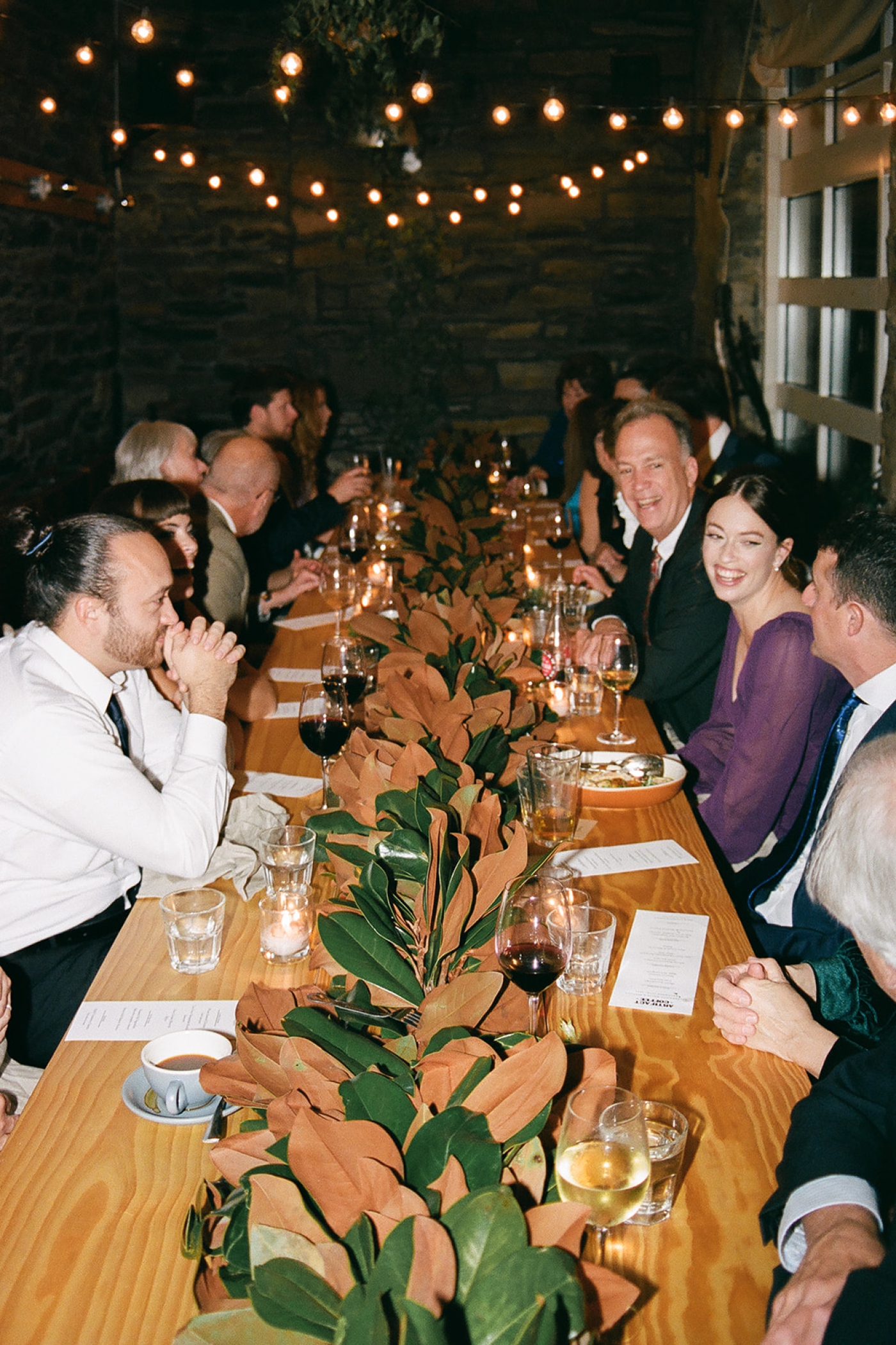 Wedding guests seated family style at Artifact Coffee in Baltimore, Maryland