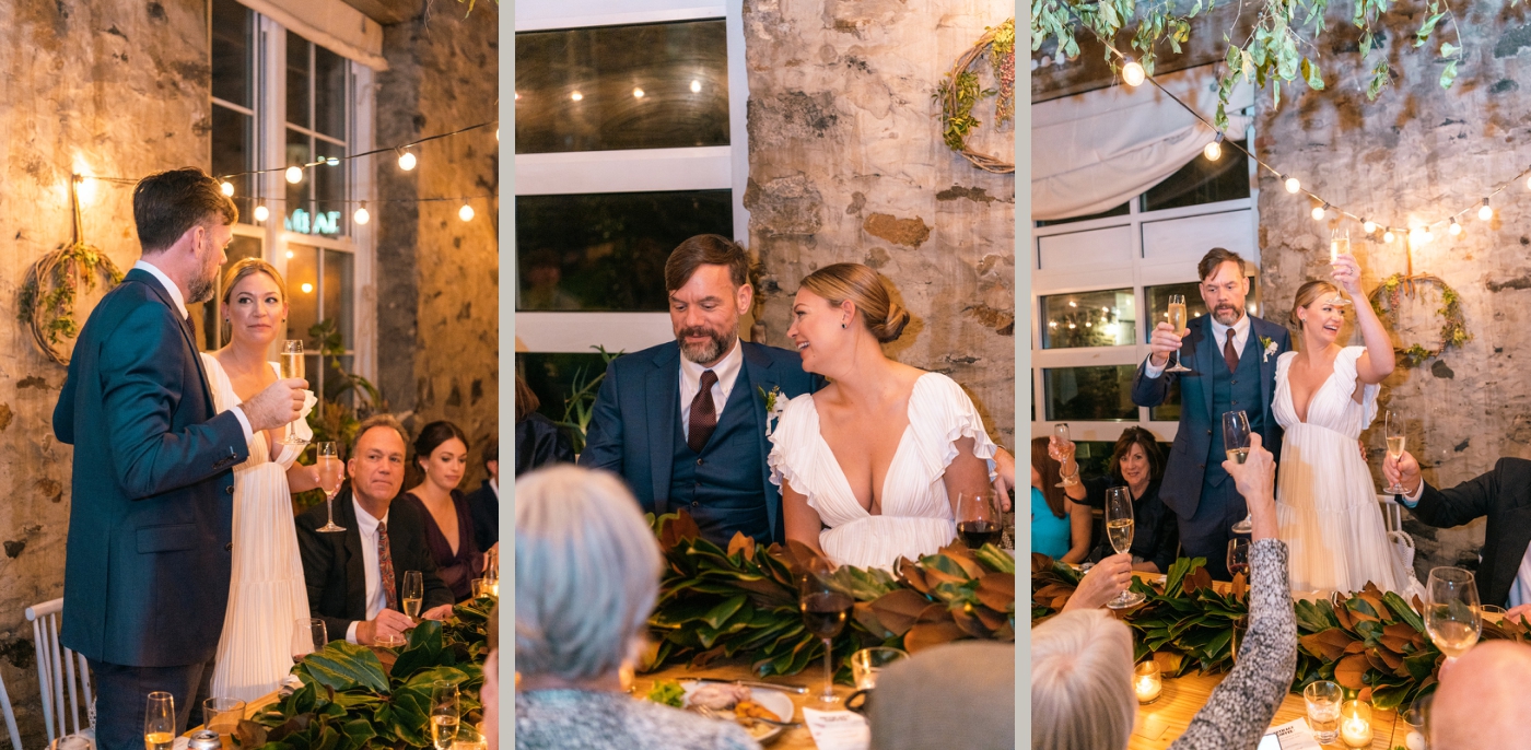 A bride and groom stand at the table and give a speech to their guests